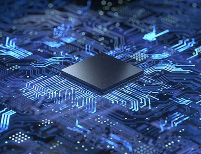 A silicon chip placed on a stylised blue pcb with glowing tracks.