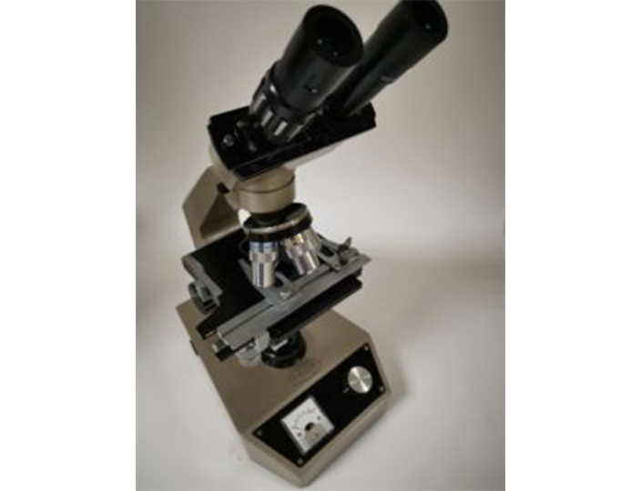 A old manual microscope manufactured by Prior Scientific.