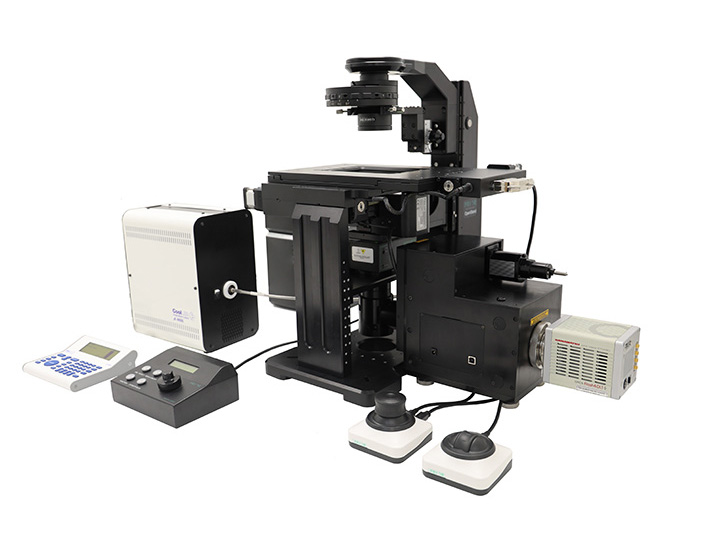 A black inverted modular microscope with a confocal imaging unit and LED illumination source.